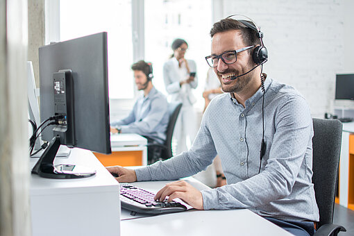 Guy_on_PC_Smiling Guy is sitting on PC and smiling, helpfull